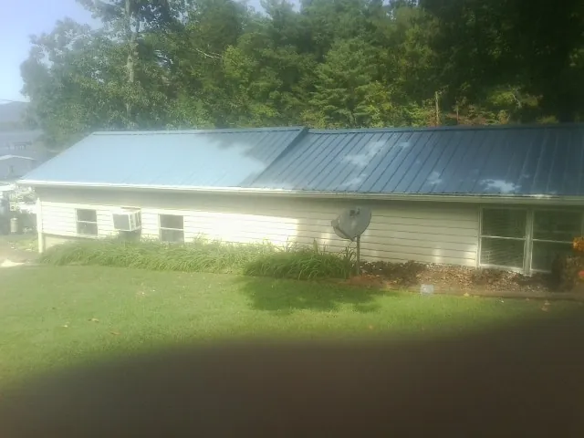 Blue metal roof running the length of a single story home in Corning